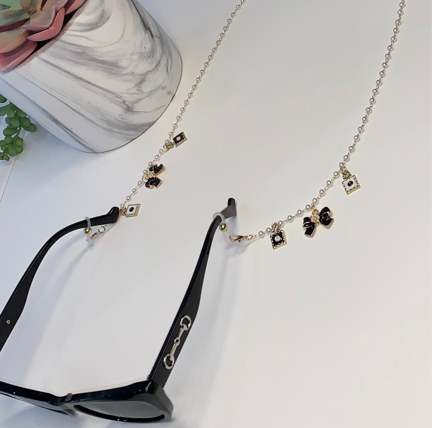 Gold and white bow sunglasses charm