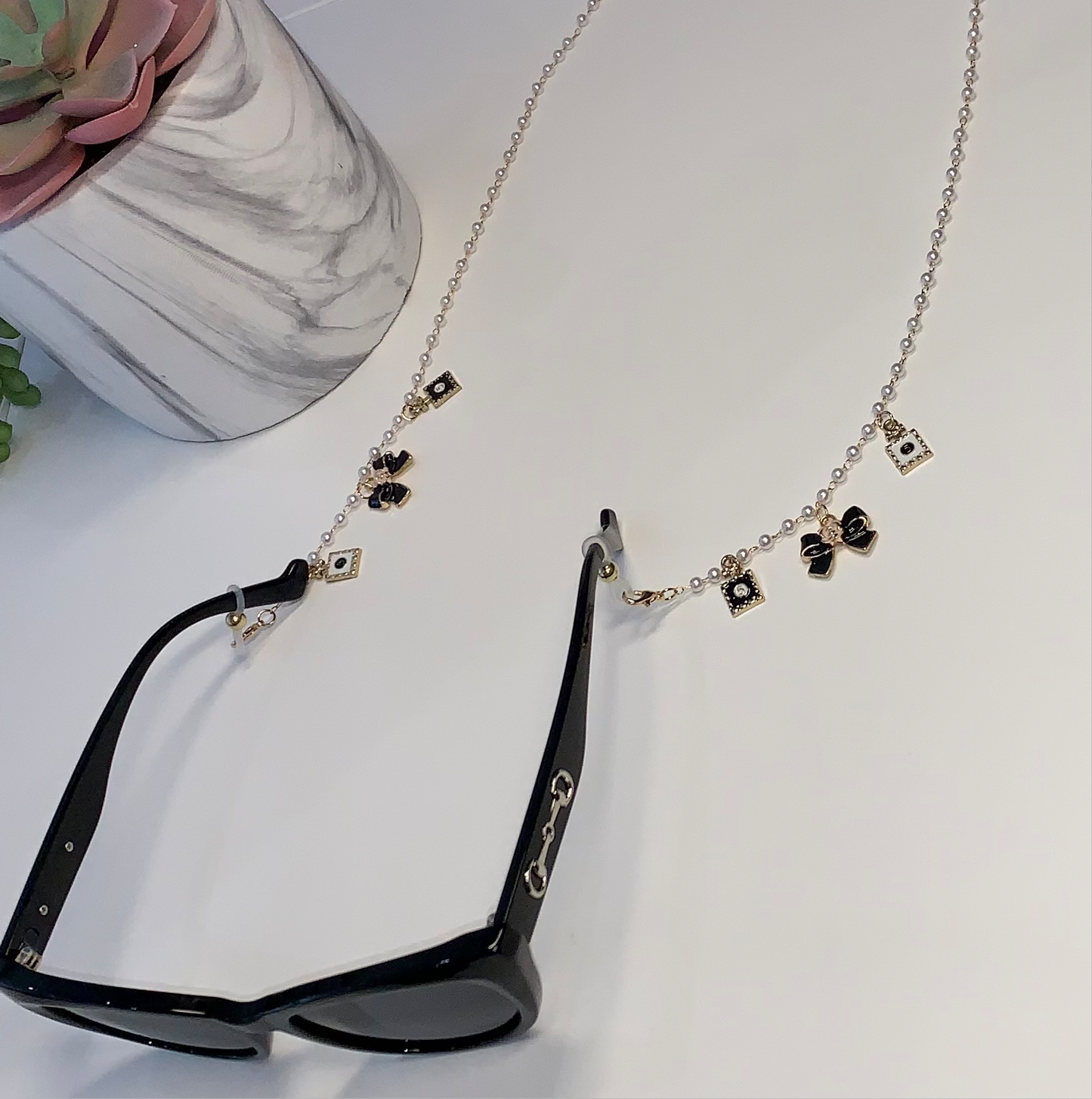 Gold and white bow sunglasses charm